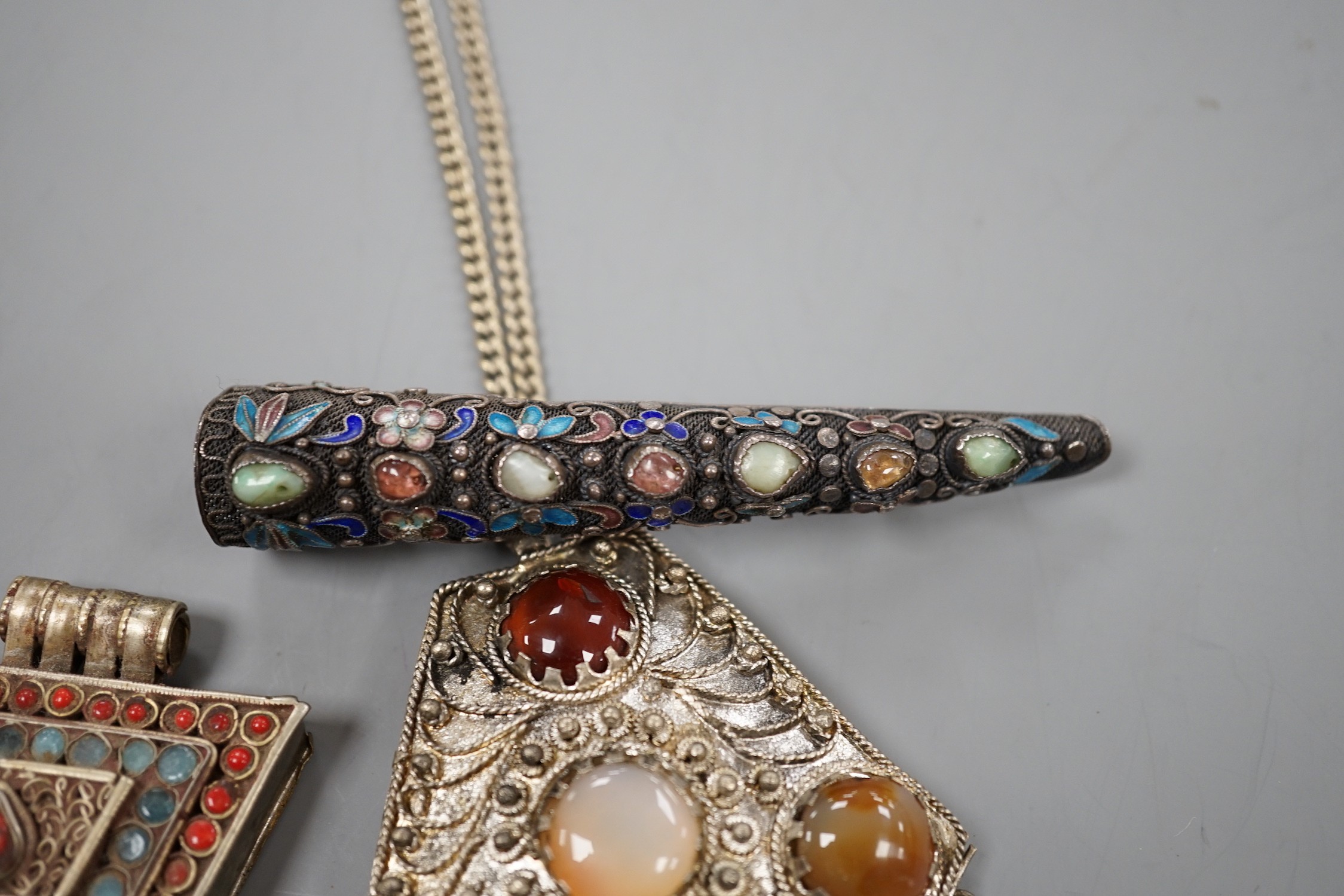 A Chinese filigree white metal, hardstone and enamel set nail guard, 86mm, together with two other Middle Eastern items.